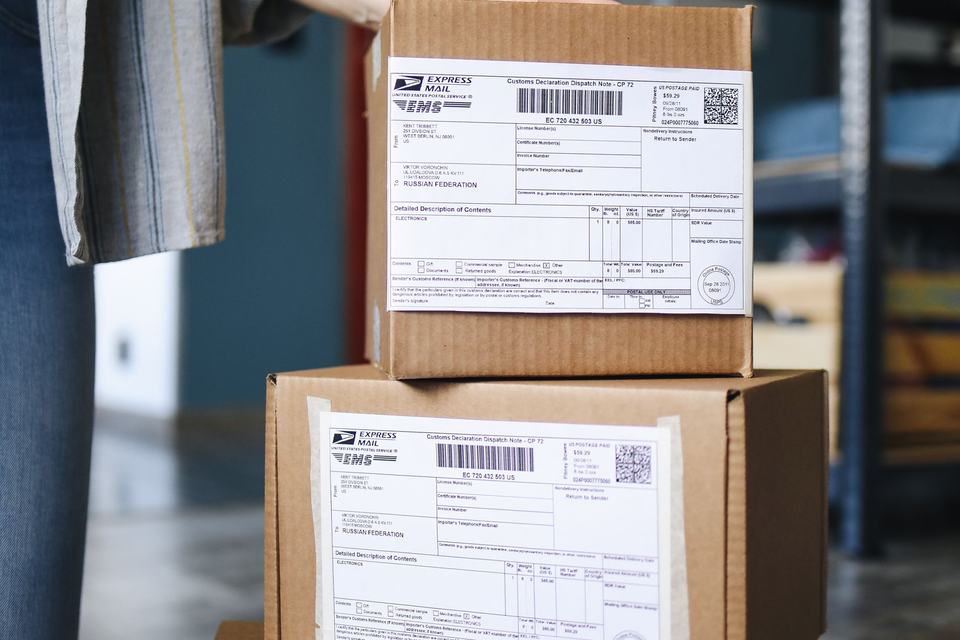 Cardboard parcels with shipping labels ready for dispatch. Illustrative photo.