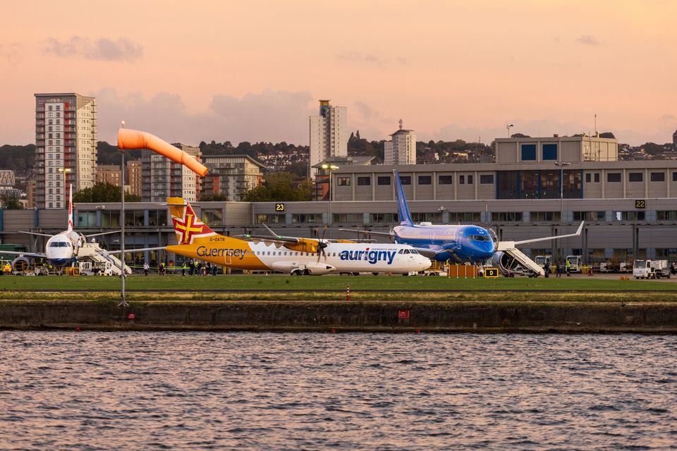 Airplanes near the airport against the background of the sunset sky
