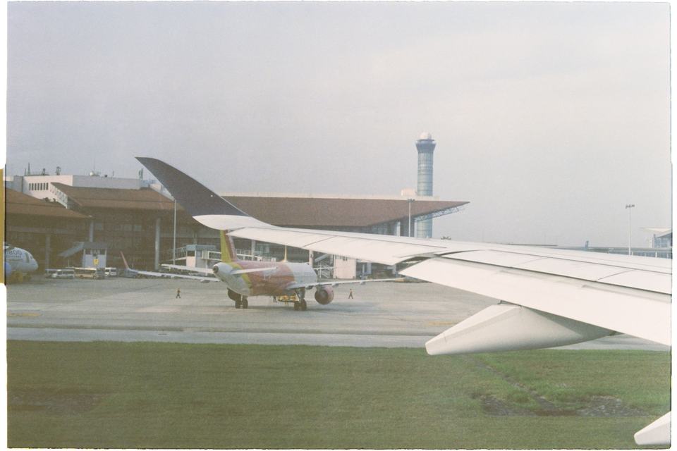 Airplanes at the terminal and airport control tower