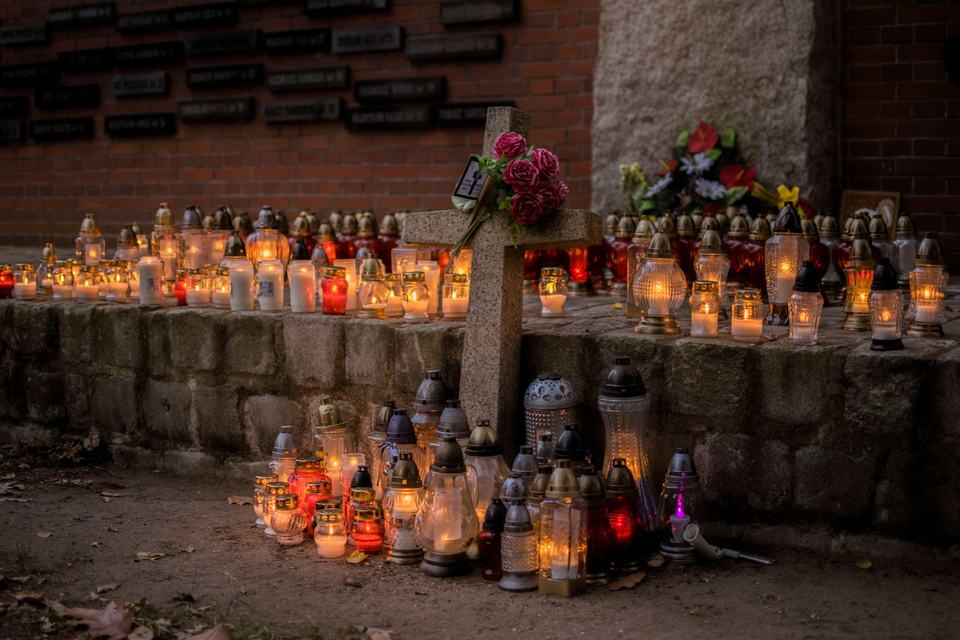 Candles and cross in a cemetery on All Saints' Day