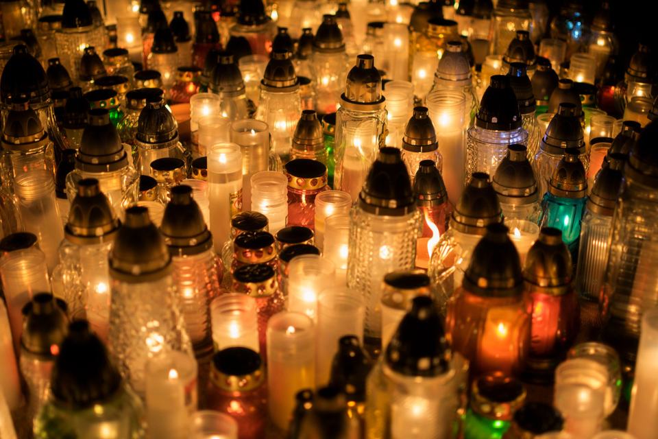 Warm light of funeral candles in the cemetery
