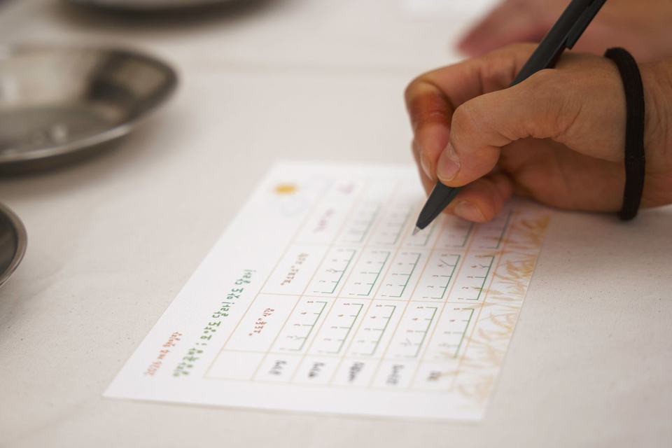 Filling out a paper form with a pen at the table