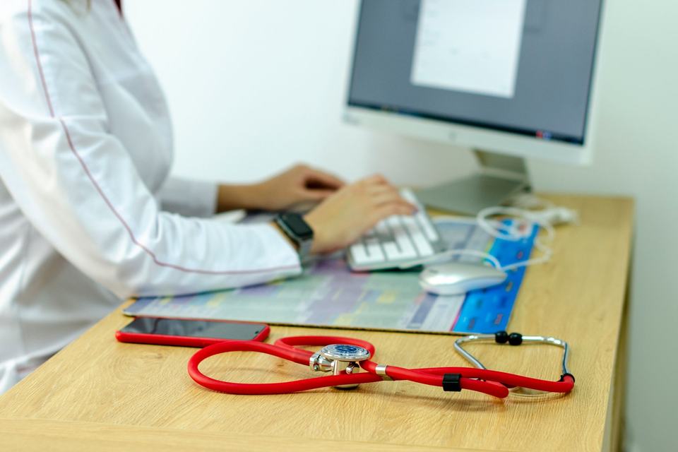 Medical specialist desk with computer and stethoscope